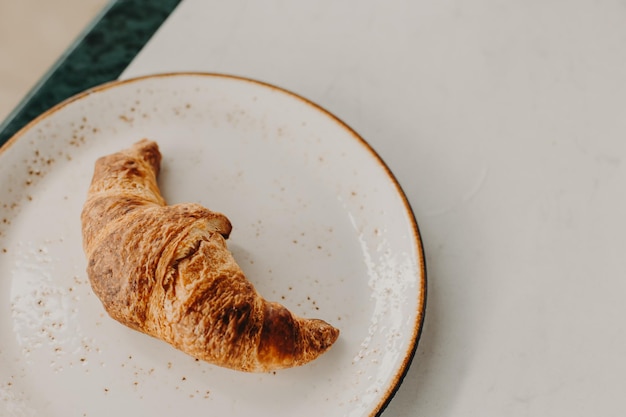 Tasty french croissant on a table in a street cafe Selective focus