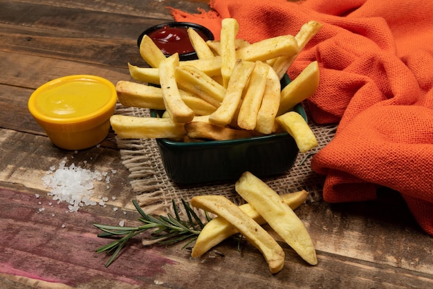 Tasty french fries on plate on bowl