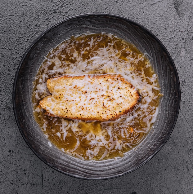 Tasty french onion soup in bowl