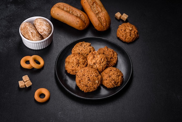 Tasty fresh oat cookies on a dark concrete background Delicious wholesome sweets