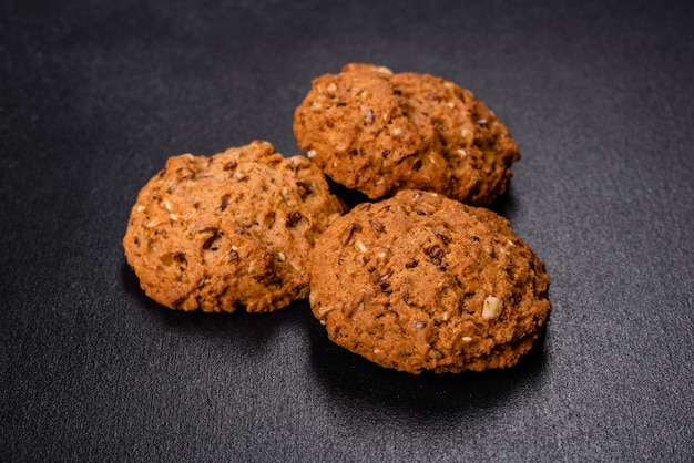 Tasty fresh oat cookies on a dark concrete background Delicious wholesome sweets