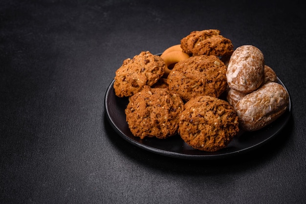 Tasty fresh oat cookies on a dark concrete background Delicious wholesome sweets