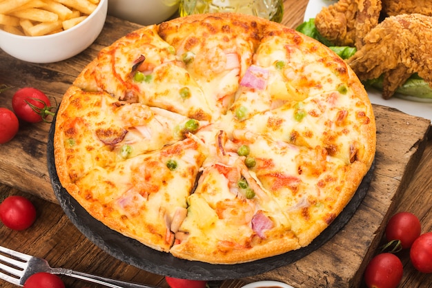 Tasty fresh pizza with seafood on table