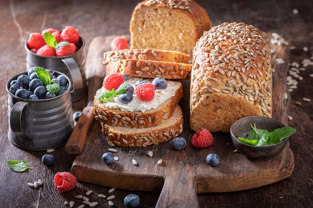 Tasty and fresh whole grain bread with blueberries and raspberries