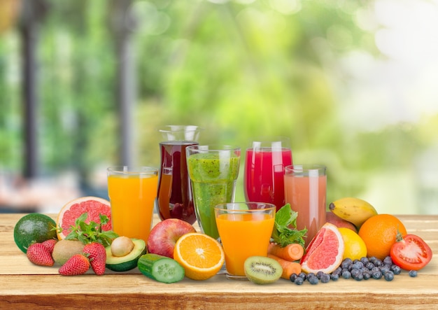 Tasty fruits  and juice with vitamins on background