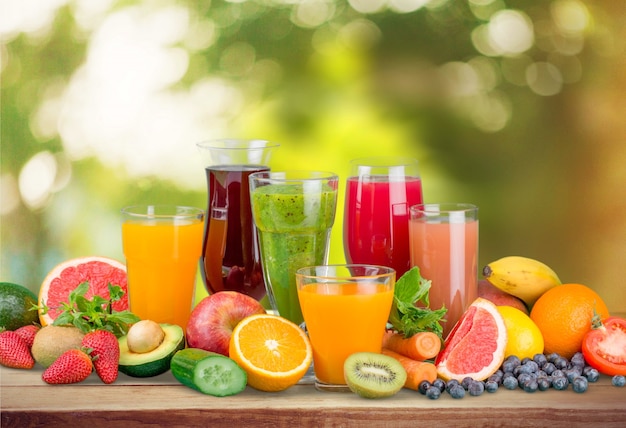 Tasty fruits  and juice with vitamins on background