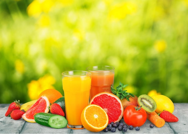 Tasty fruits  and juice with vitamins on background