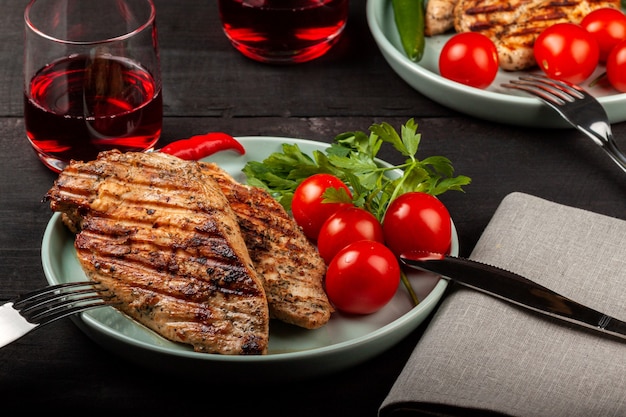 Tasty grilled chicken with fresh tomatoes on a dish