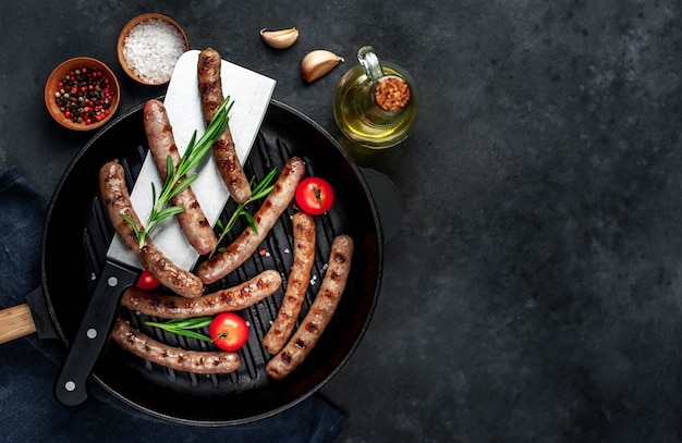 Tasty grilled sausages with spices and rosemary