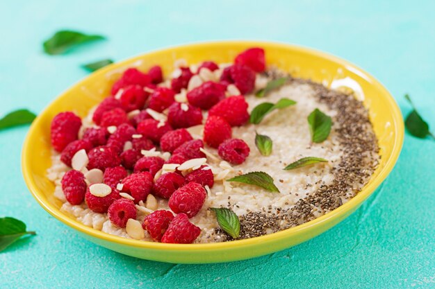 Tasty and healthy oatmeal porridge with raspberry and flax chia. Healthy breakfast. 