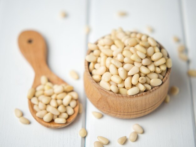 tasty and healthy pine nuts in a wooden bowl and spoon