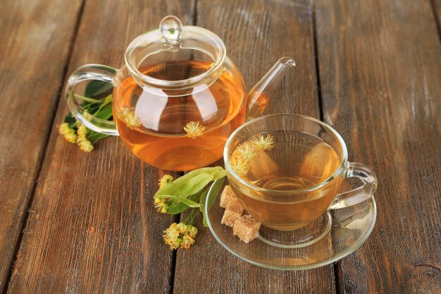 Tasty herbal tea with linden flowers on wooden table