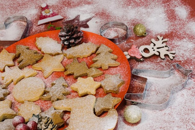 Tasty homemade Christmas cookies, closeup.Gingerbread cookies on a red background. Selective focus.