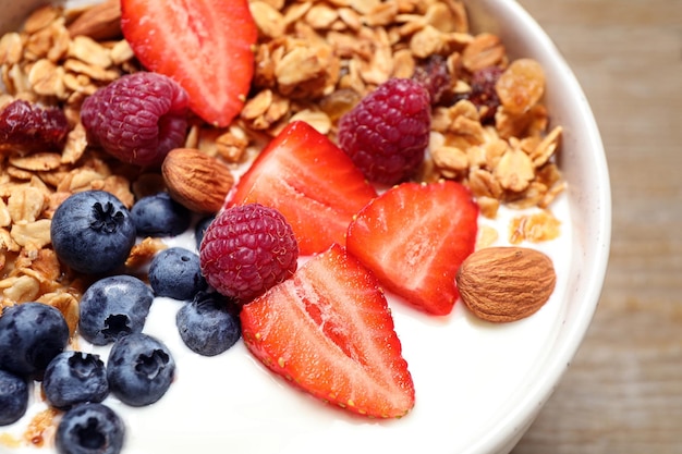 Tasty homemade granola served on wooden table closeup Healthy breakfast