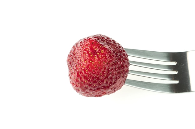 Photo tasty juicy red strawberry put on a fork on a white plate in isolation closeup