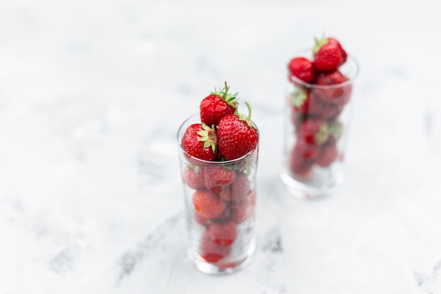 tasty juicy strawberries in a glass on a white background.  Healthy food concept