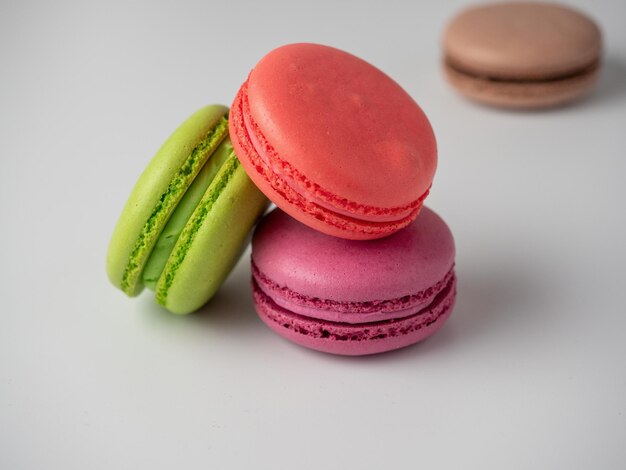 Tasty macaroons on a white background. Side view. Delicious sweet dessert