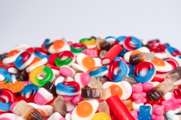 Tasty mix of jelly colorful candies isolated on a white background