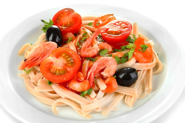 Tasty pasta with shrimps black olives and tomatoes isolated on white