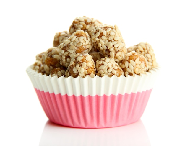 Tasty peanuts with sesame and caramel isolated on white