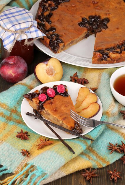 Tasty pie on plate on wooden table