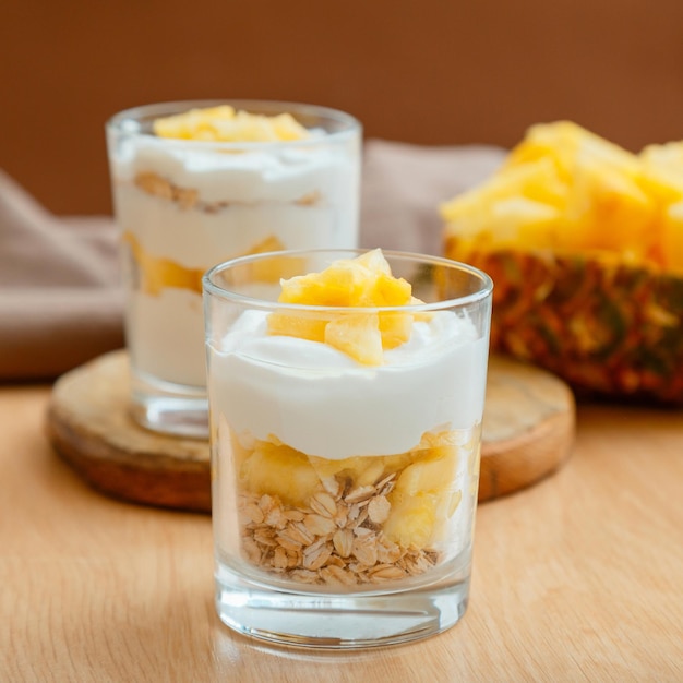 Tasty pineapple desserts with chopped fresh juicy pineapple breakfast dessert with oat granola