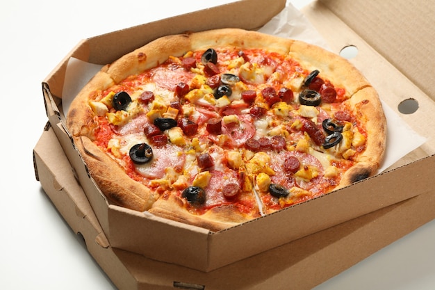 Tasty pizza in carton box on white