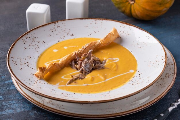 Tasty pumpkin soup with duck Autumn soup