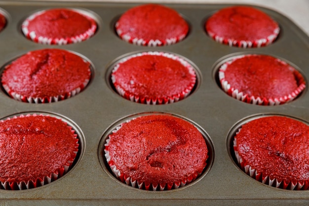 Tasty red velvet cupcakes in oven pen. Close up.