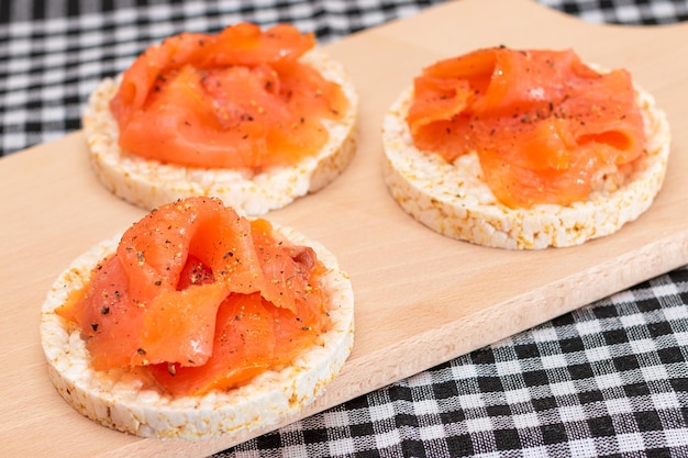 Tasty rice cake sandwiches with fresh salmon slices