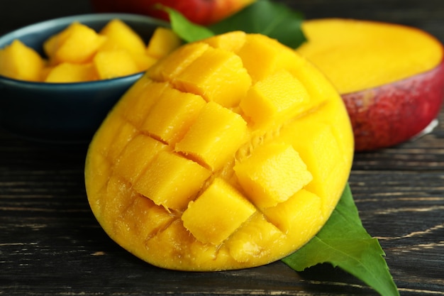 Tasty ripe mango fruit on wooden table