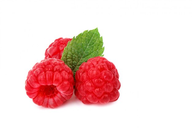 Tasty ripe raspberries on a white surface