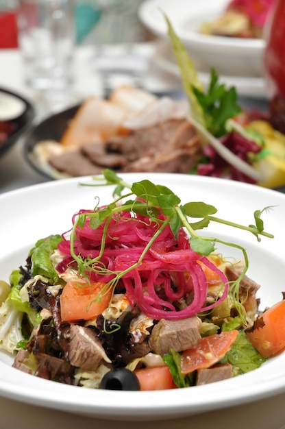 Tasty salad with beef and vegetables at a Banquet in a restaurant