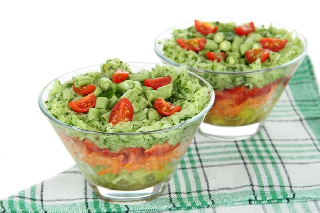 Tasty salad with fresh vegetables isolated on white