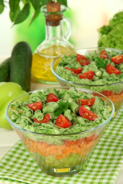 Tasty salad with fresh vegetables on wooden table