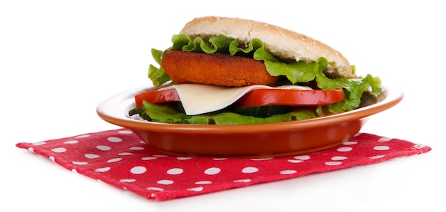 Tasty sandwich with cutlet on color plate on napkin isolated on white