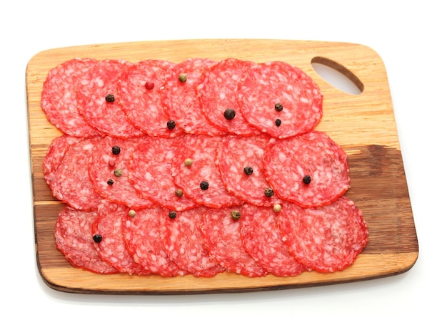 Tasty sausage with spices on wooden cutting board isolated on white