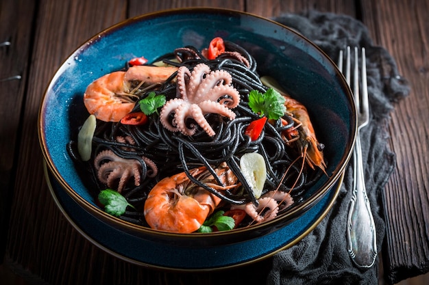 Tasty seafood black pasta made of octopus tiger prawns