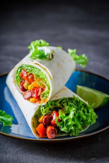 Tasty and spicy burrito with vegetables and lime