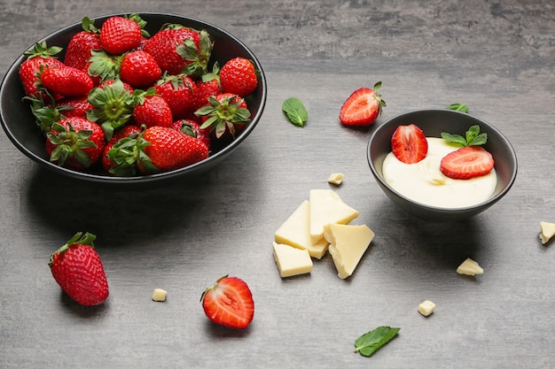 Tasty strawberry with melted chocolate on dark