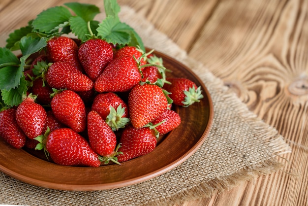 Tasty strawberry on a wooden table.