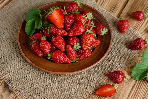 Tasty strawberry on a wooden table. 