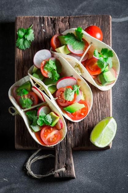 Tasty tacos with avocado and fresh coriander