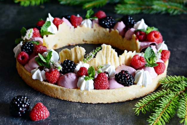 Tasty tart with air cream and forest fruits