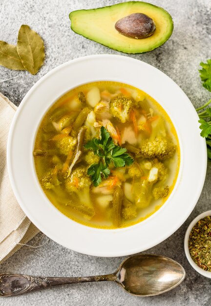 Tasty vegetables and spices soup on a gray concrete background. It can be used as a background