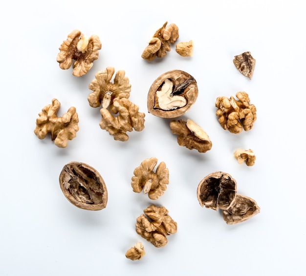 Tasty walnuts on white surface