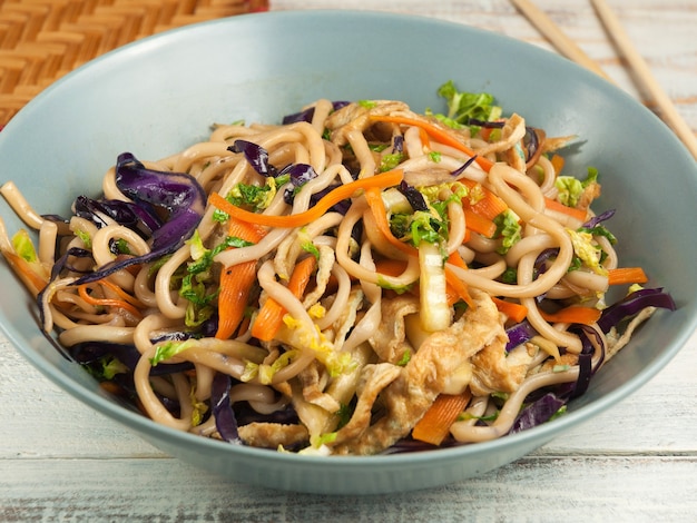 Tasty wheat noodles with vegetables and omelet. Asian cuisine