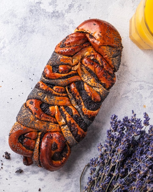 Tasty wicker bun with poppy seeds Top view