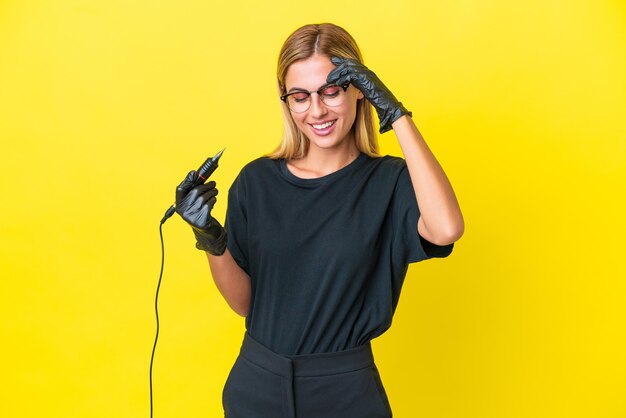 Tattoo artist Uruguayan woman isolated on yellow background laughing