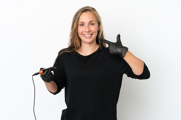 Tattoo artist woman isolated on white background giving a thumbs up gesture